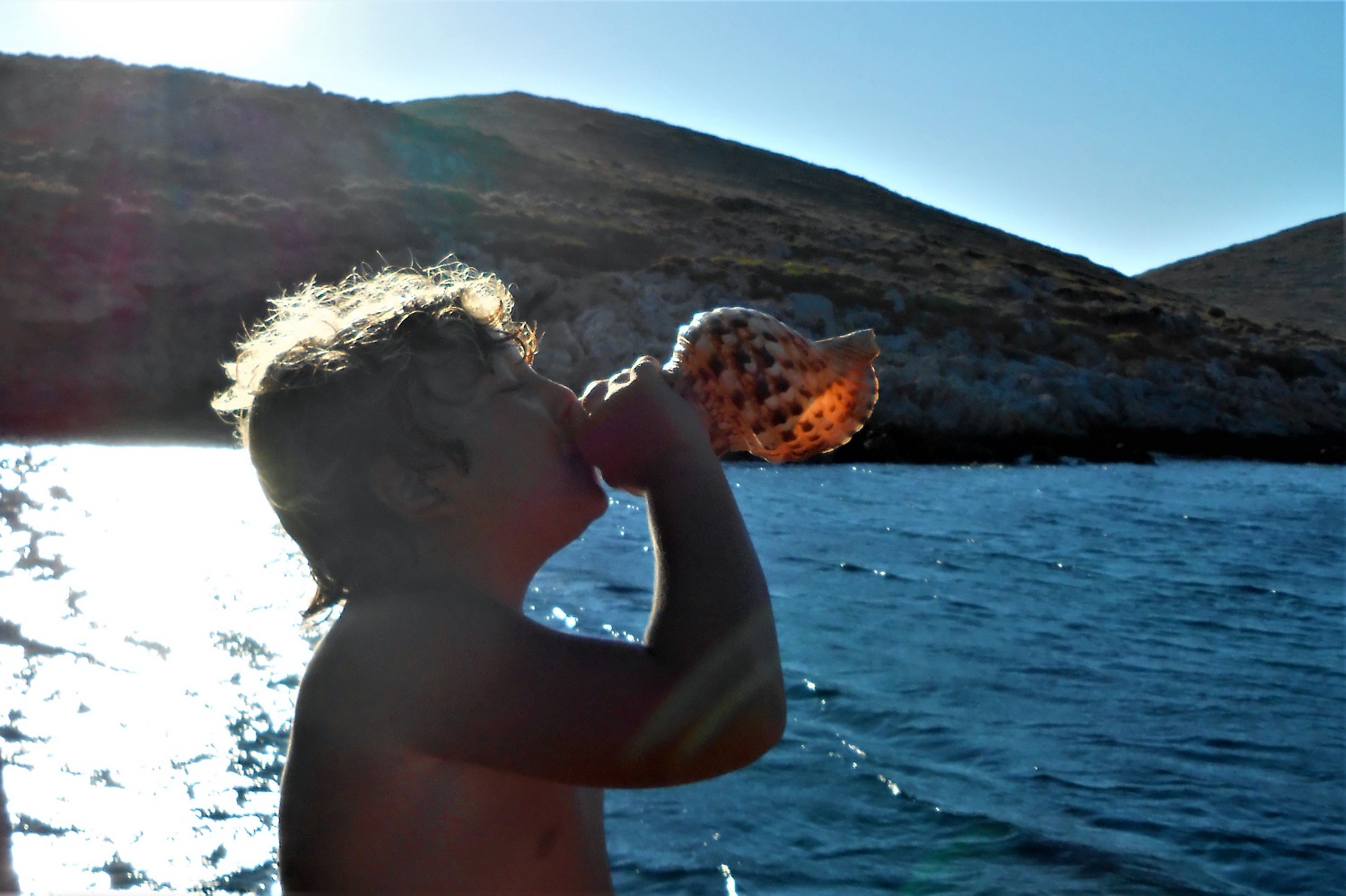 greek summer kids play sea shell